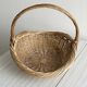 Large antique woven wicker basket with handle.
