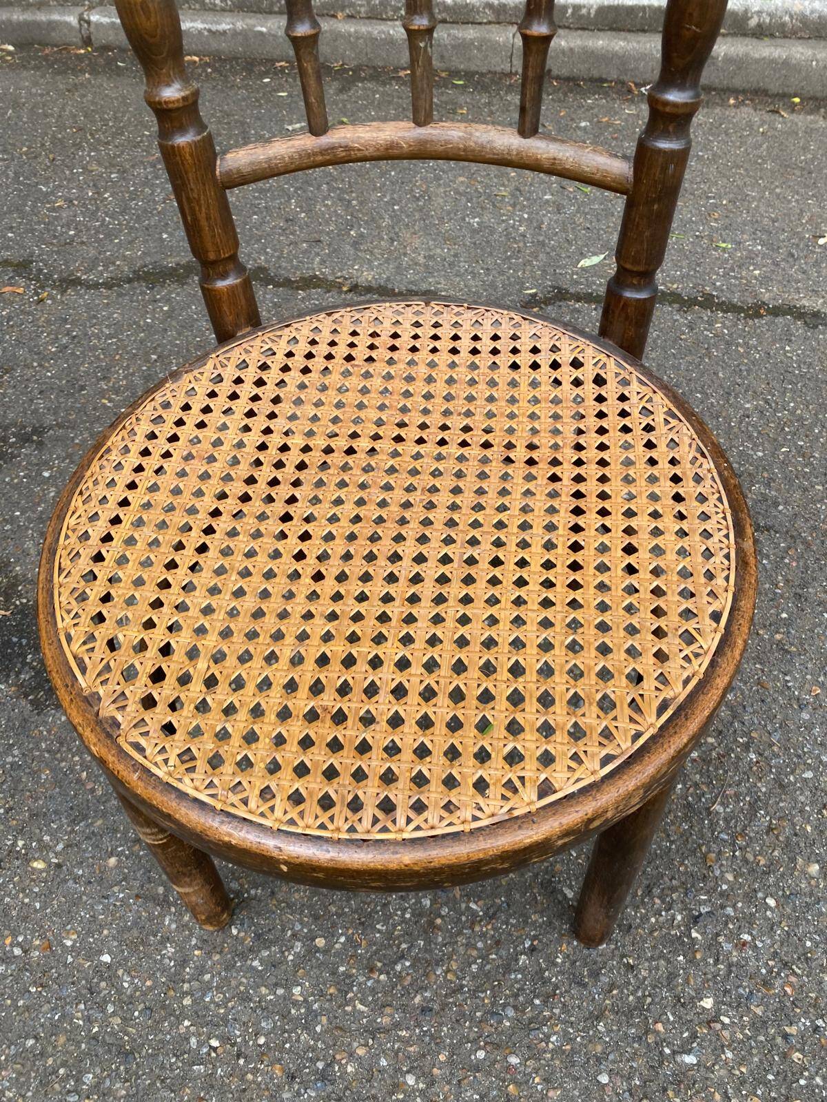 Vintage 19th-century bistro chair made of curved solid wood and caned in the Thonet style.