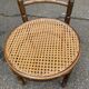 Vintage 19th-century bistro chair made of curved solid wood and caned in the Thonet style.