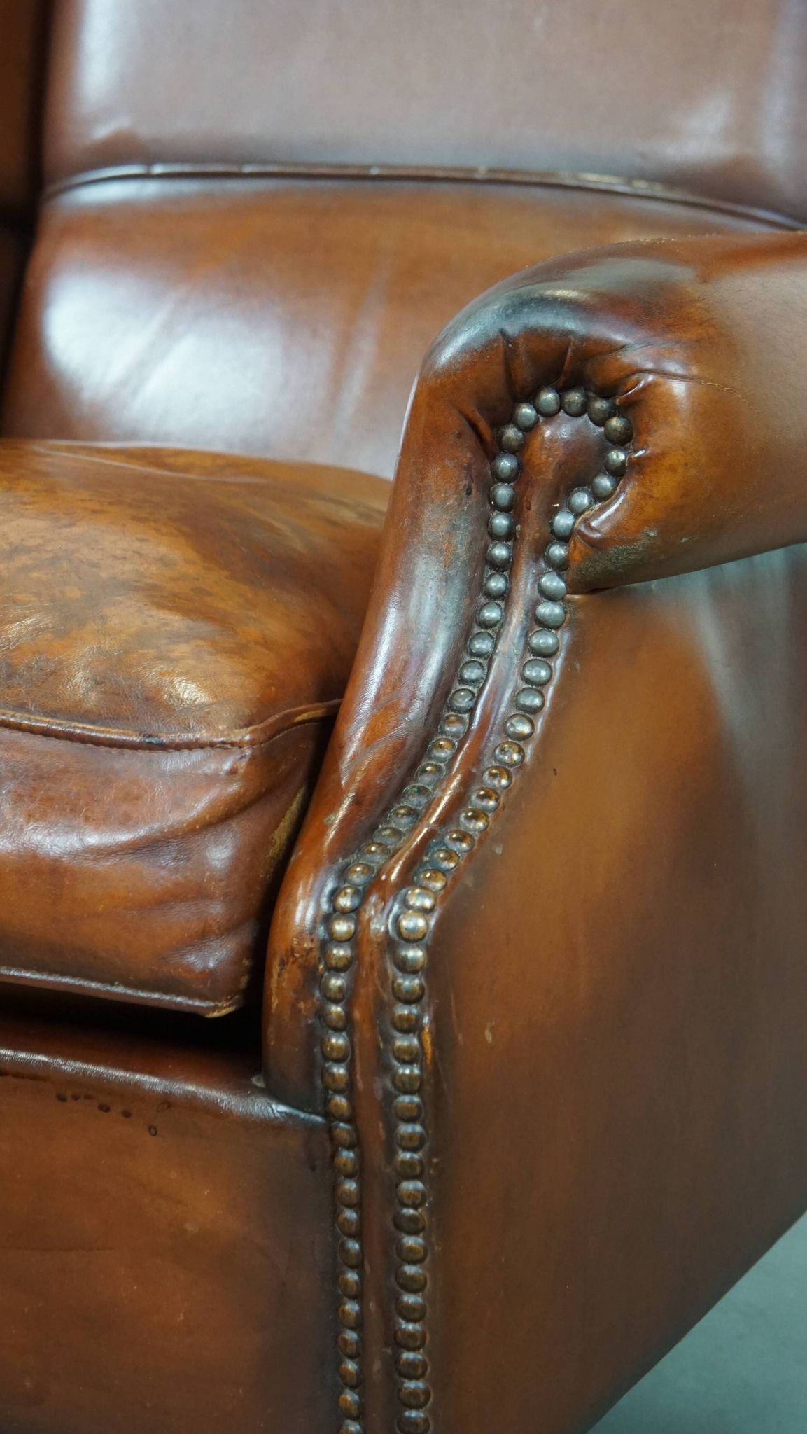 Sheepskin leather wingback chair with patina