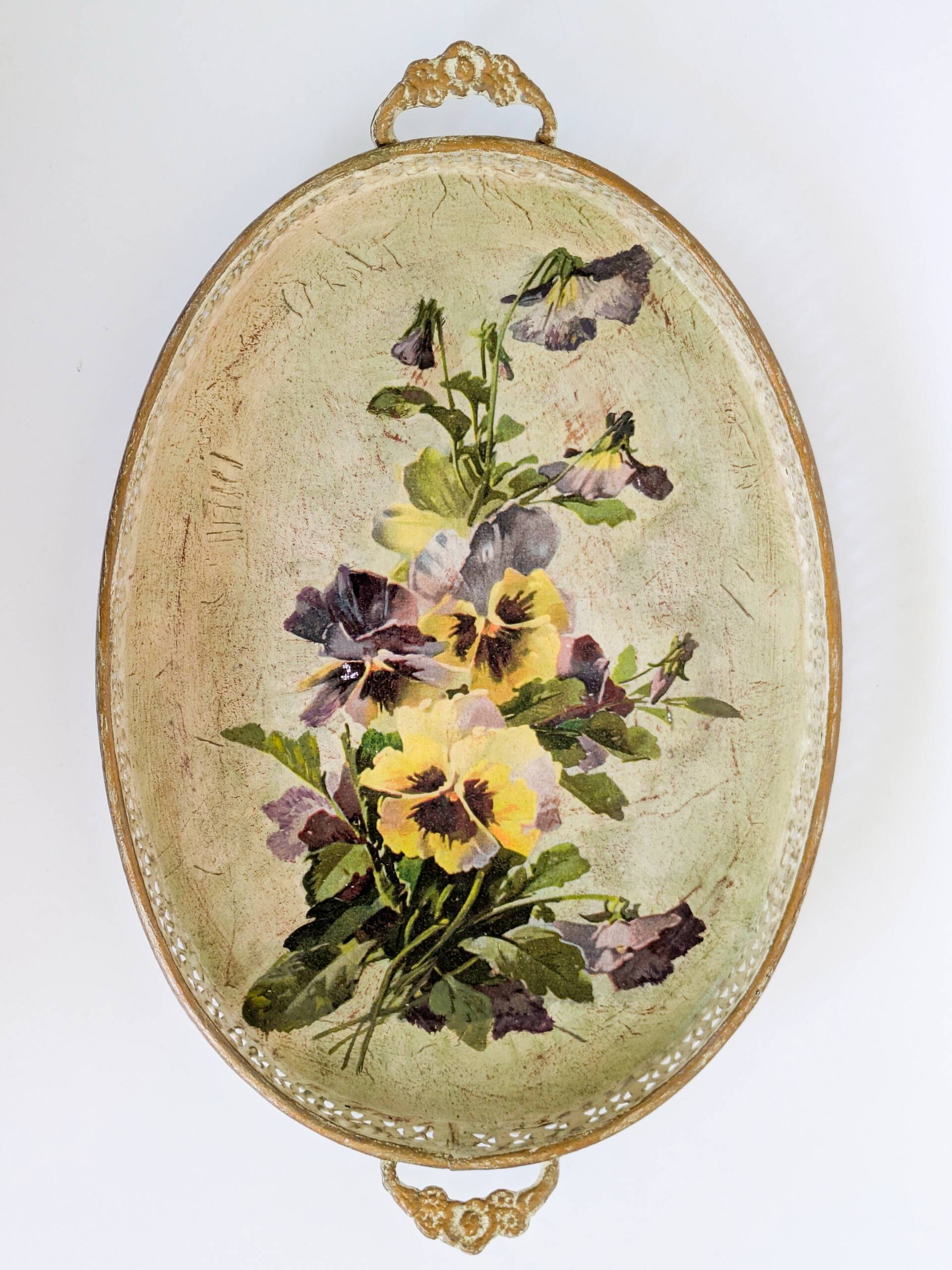Oval metal decorative vintage tray with floral pattern.