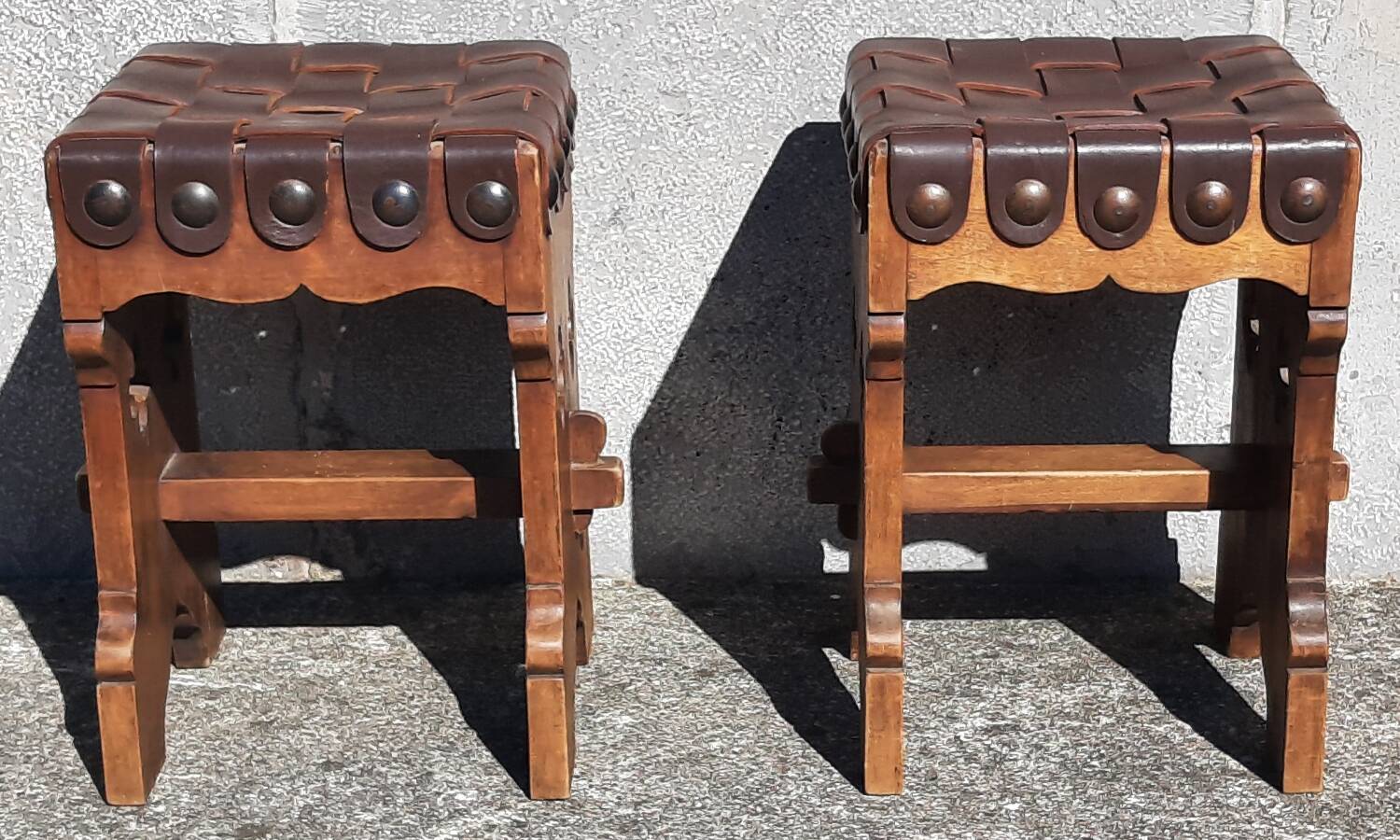 Pair of brutalist stools, leather seat.
