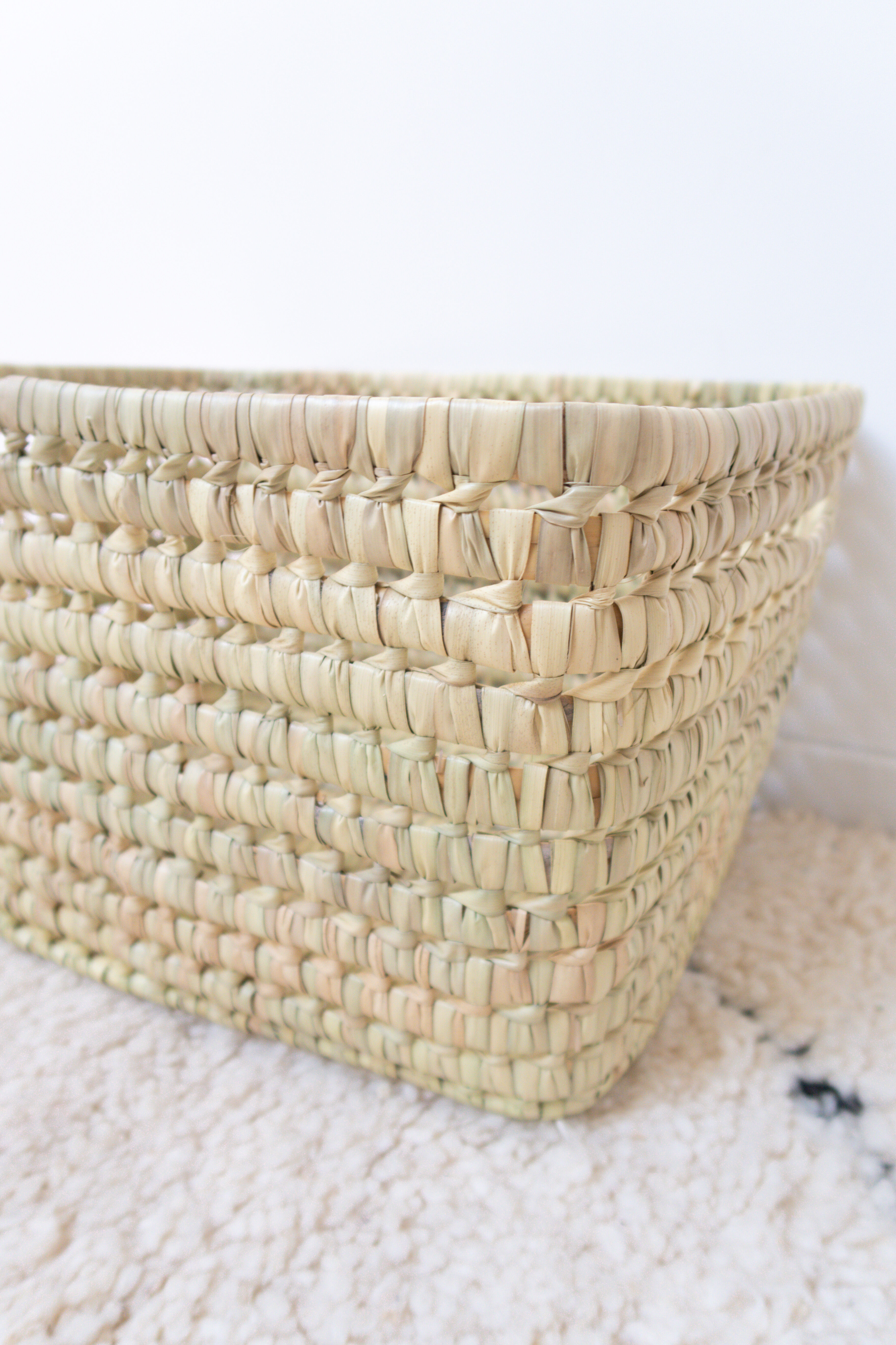 Storage basket in braided palm leaves