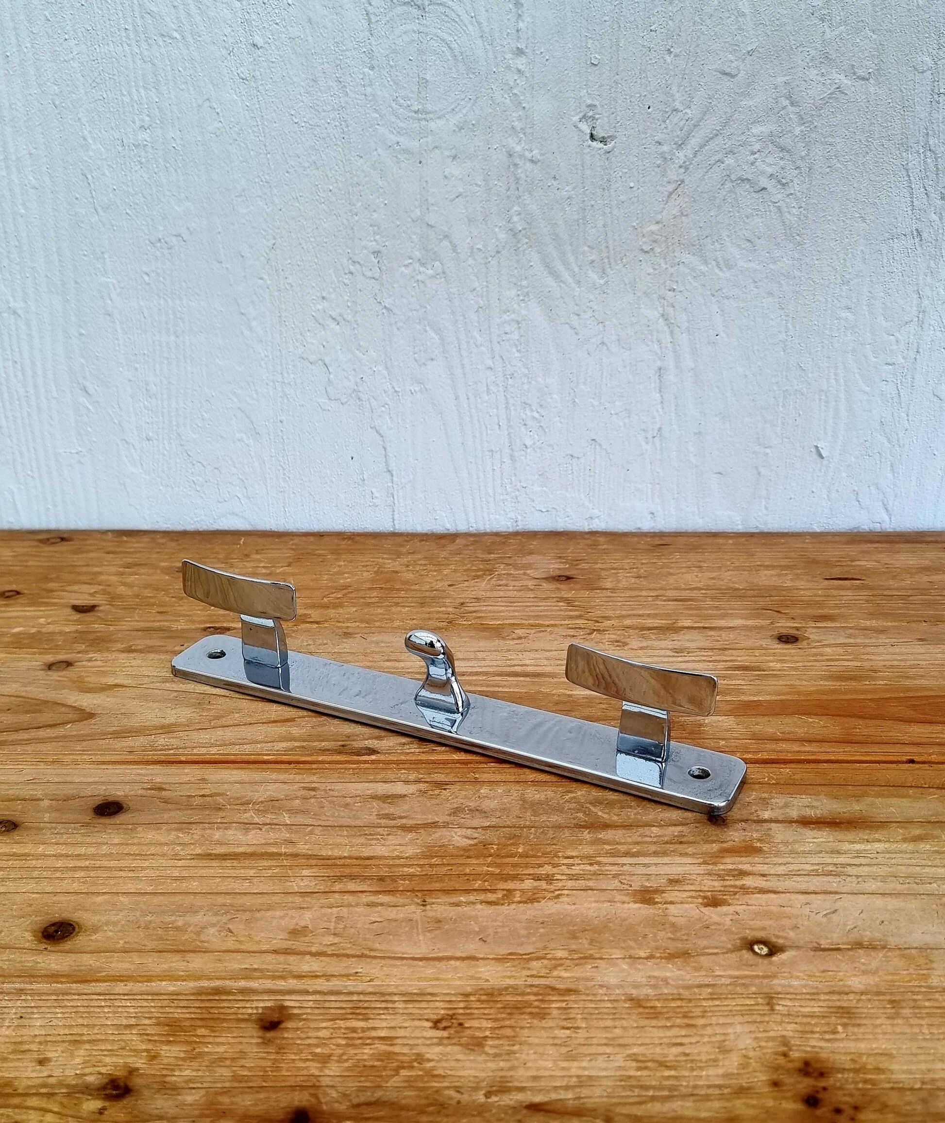Vintage chrome wall coat rack with three hooks.