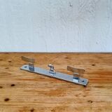 Vintage chrome wall coat rack with three hooks.