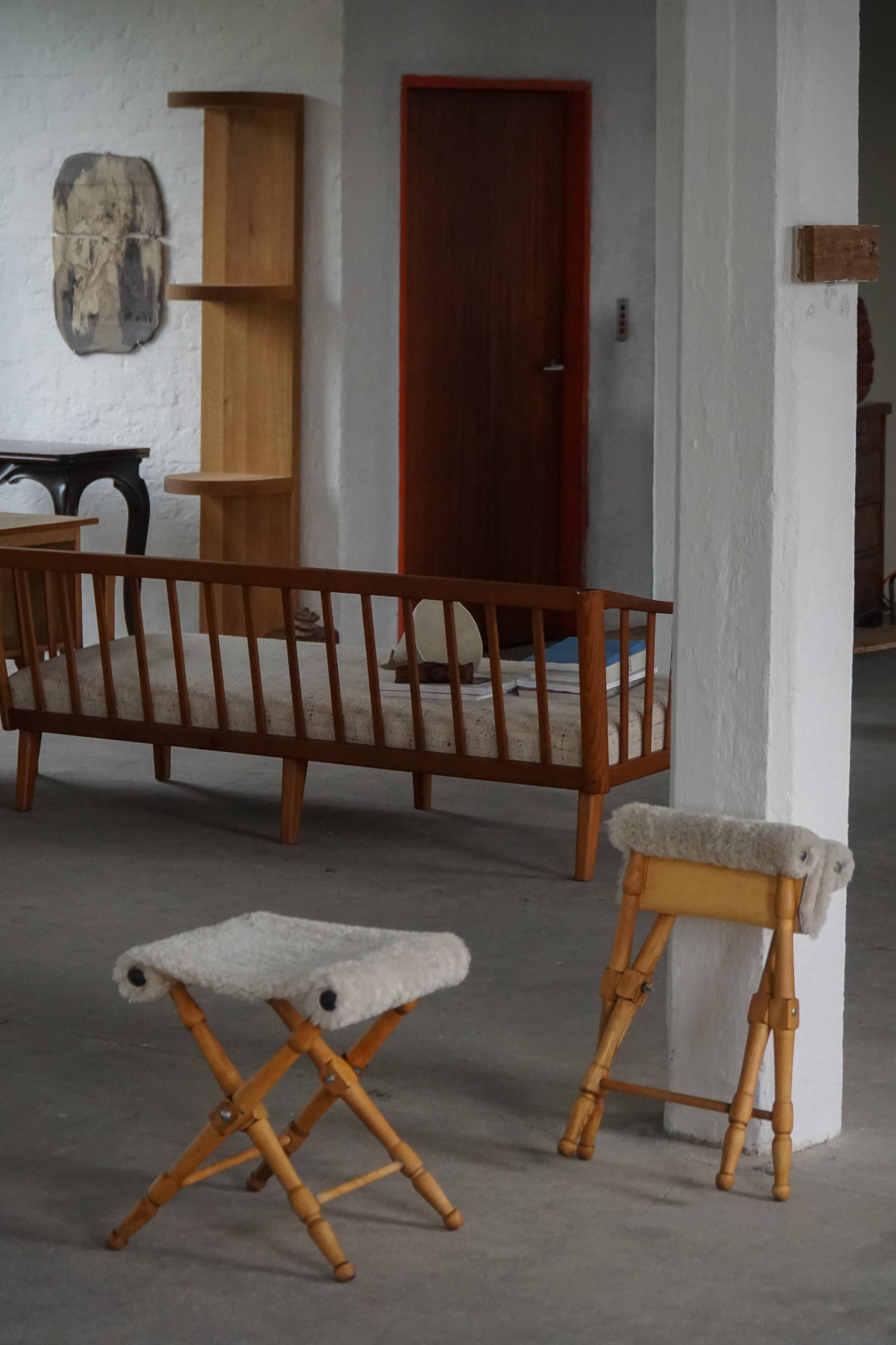 Pair of Danish mid-century folding stools with sheepskin upholstery, 1960.