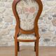 Antique Louis XVI style chair in wood and floral fabric.