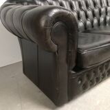 Three-seater black leather chesterfield sofa