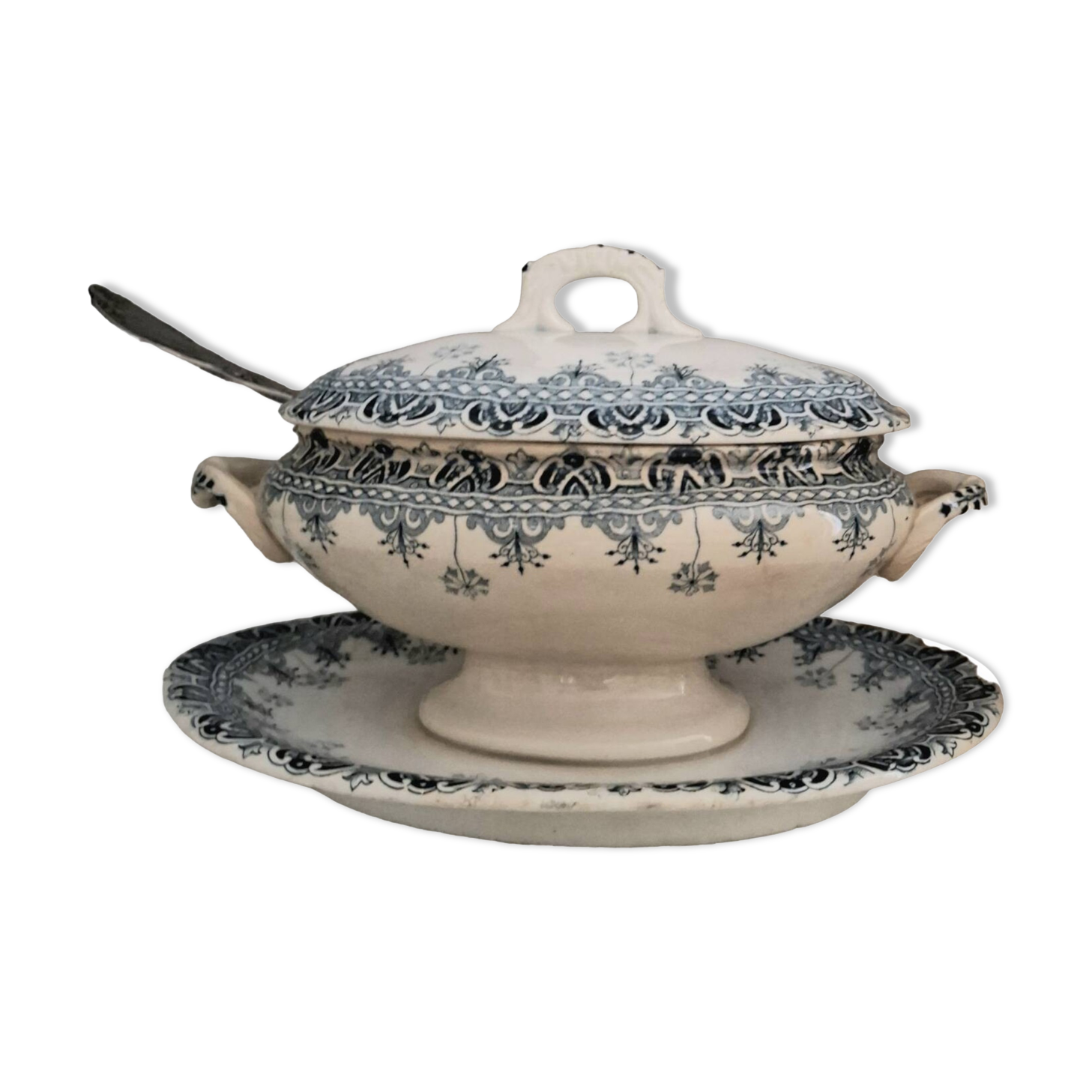 Antique iron earthenware sauceboat on a frame