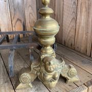 Pair of andirons and grates in cast iron and bronze with gilded grotesques, 17th century