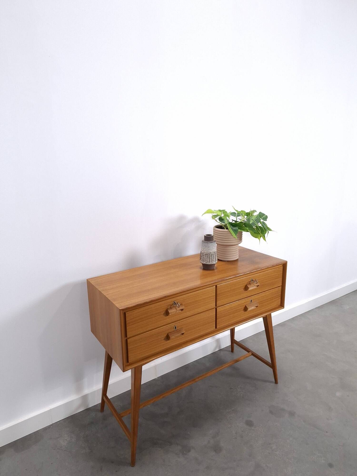 Vintage teak Danish chest of drawers with high slanted legs, side table, sideboard.