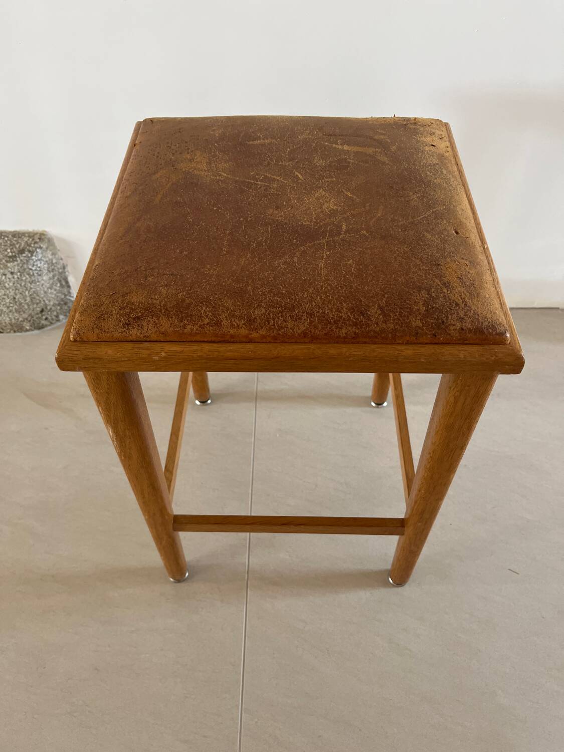 Vintage stool from the 60s with aged leather seat