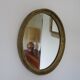 Old oval mirror in gilded wood 50s 60s