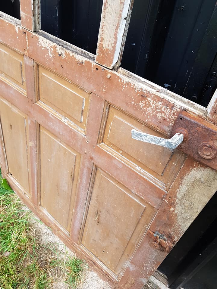 Ancient paneled solid oak door with 3 windows