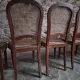 Set of 6 antique Louis XVI style dining chairs with caning.