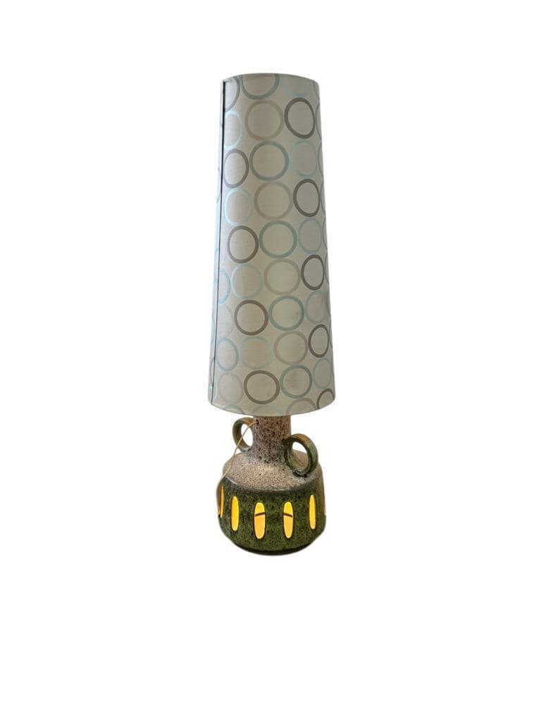 Vintage ceramic floor lamp with illuminated base.