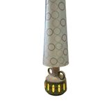 Vintage ceramic floor lamp with illuminated base.