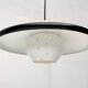 Minimalist metal and glass pendant lamp in mid-century style.