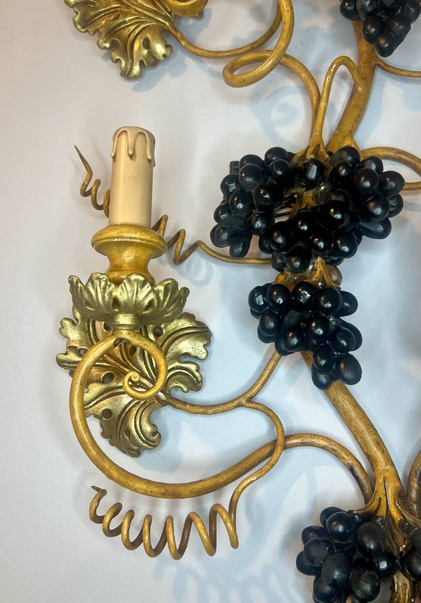 Large pair of wall sconces with vine decorations.