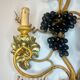 Large pair of wall sconces with vine decorations.