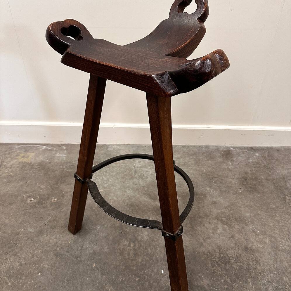 Set of 3 rustic carved oak bar stools with iron footrests, 1970s