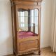 Vintage wooden display cabinet with glass shelves.
