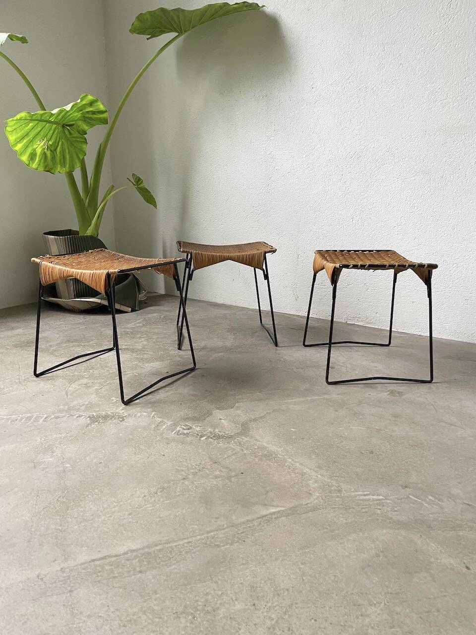 Set of three Raoul Guys wicker and metal stools