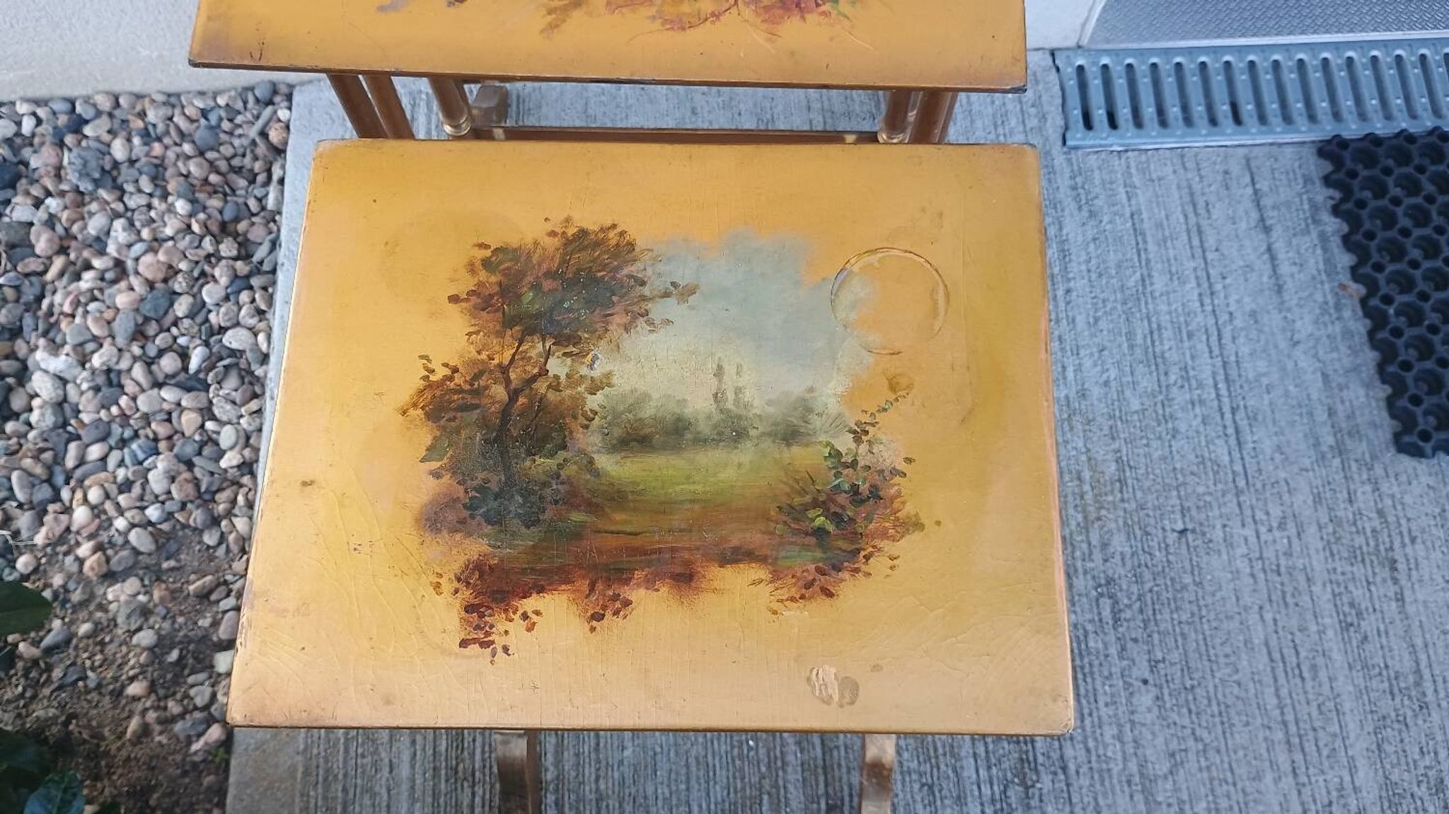Sets of three nesting tables with painted landscape decorations in poplar.