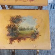 Sets of three nesting tables with painted landscape decorations in poplar.