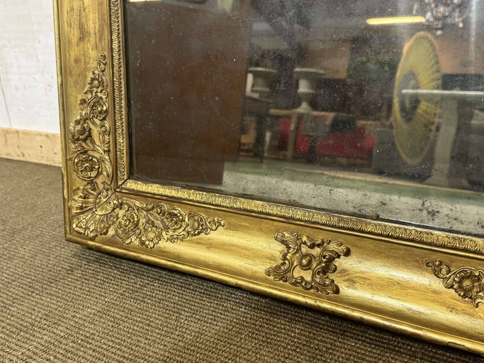 19th-century mirror in gilded wood and plaster.