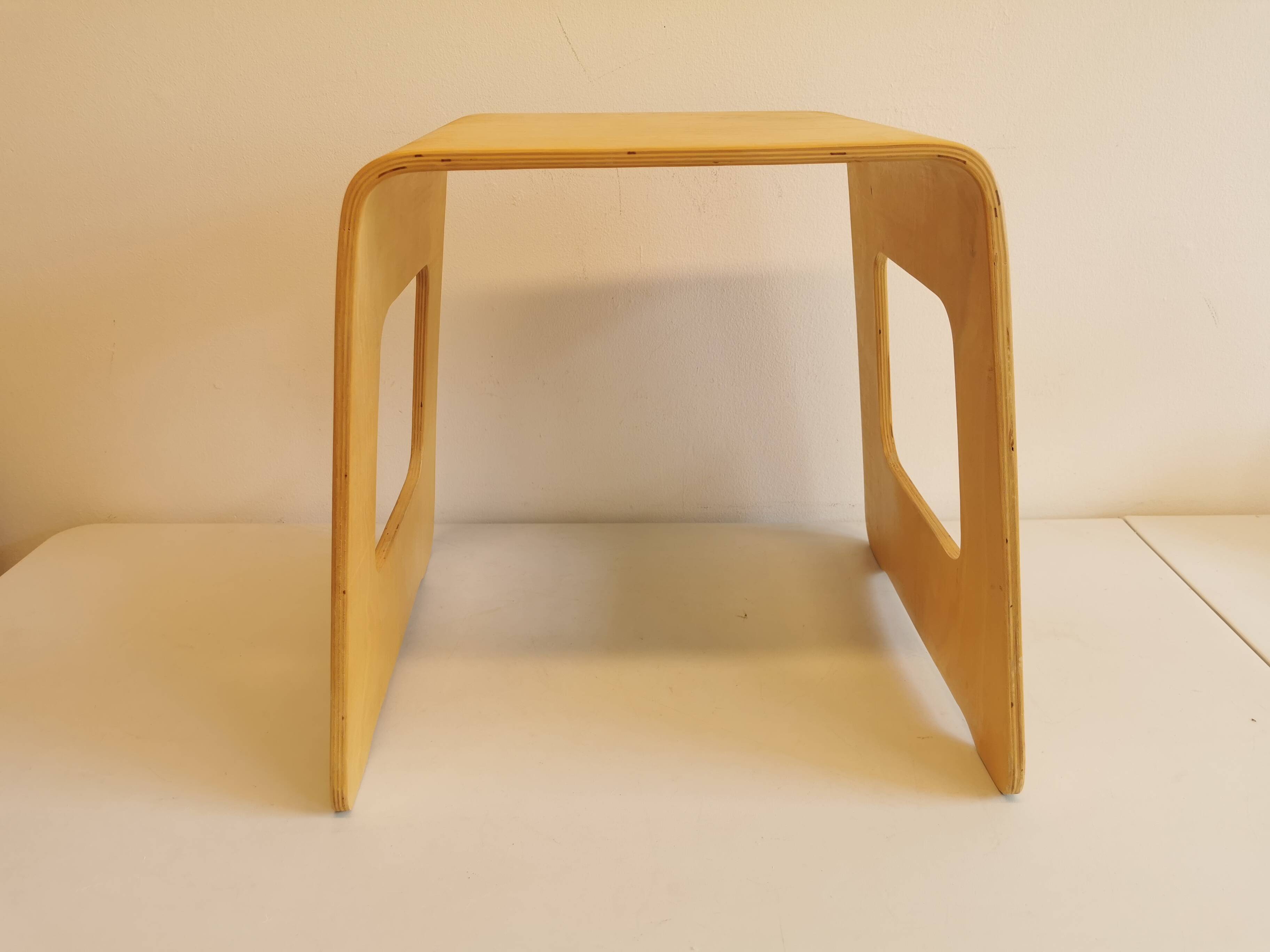 Design stool/side table made of curved plywood.