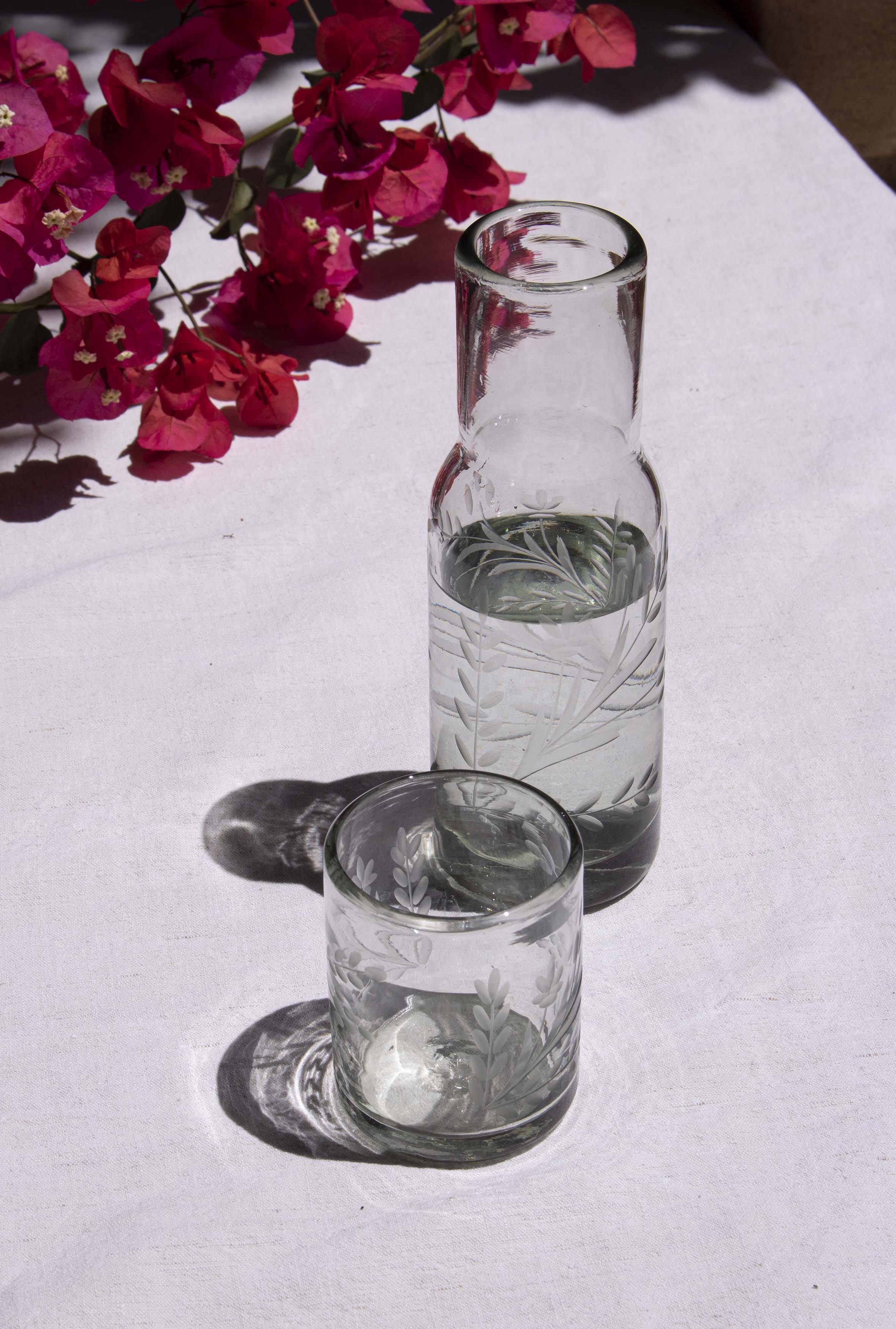 Carafe and glass made of blown and engraved glass.
