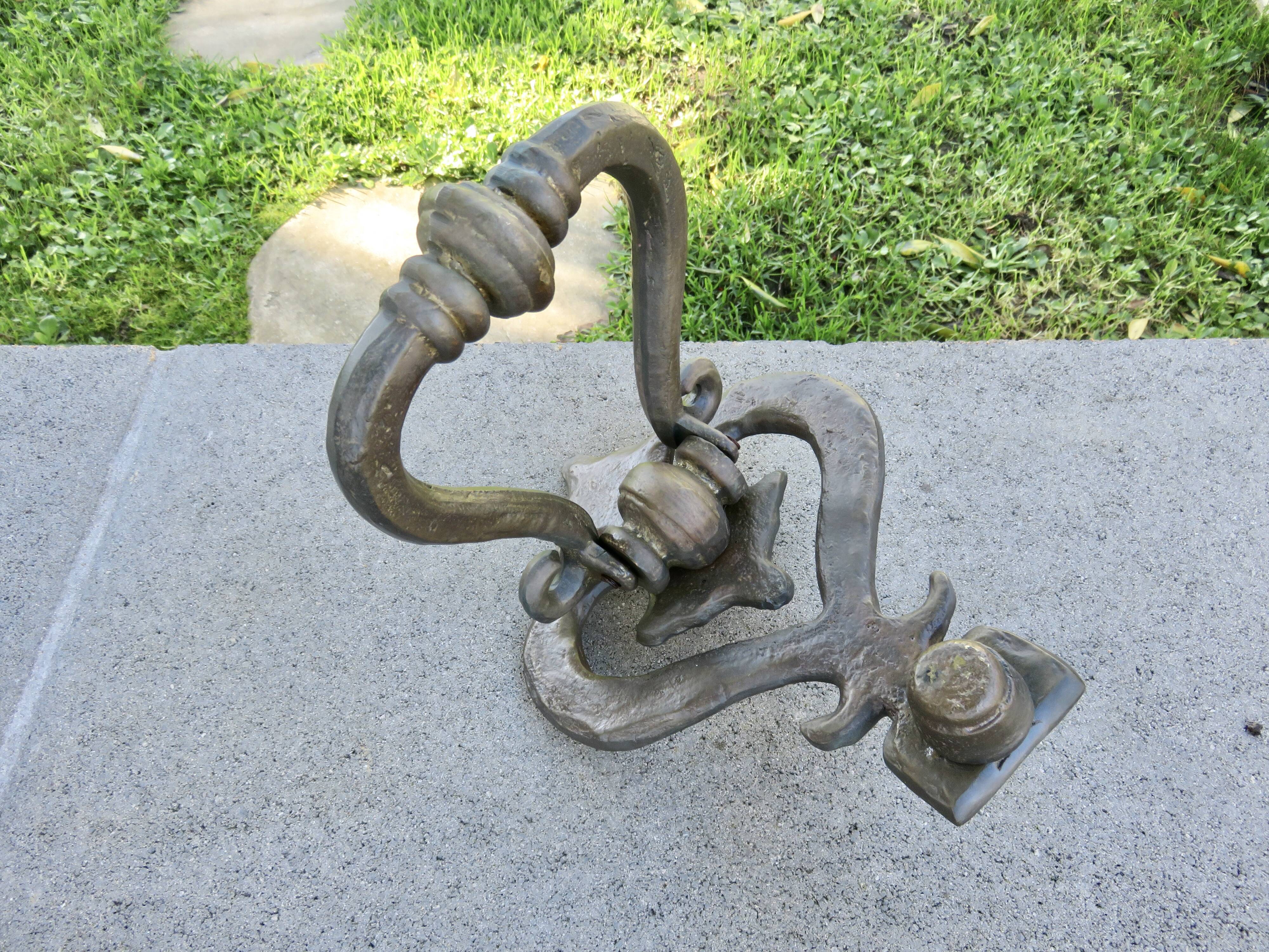 Impressive door knocker from the High Middle Ages in solid bronze.