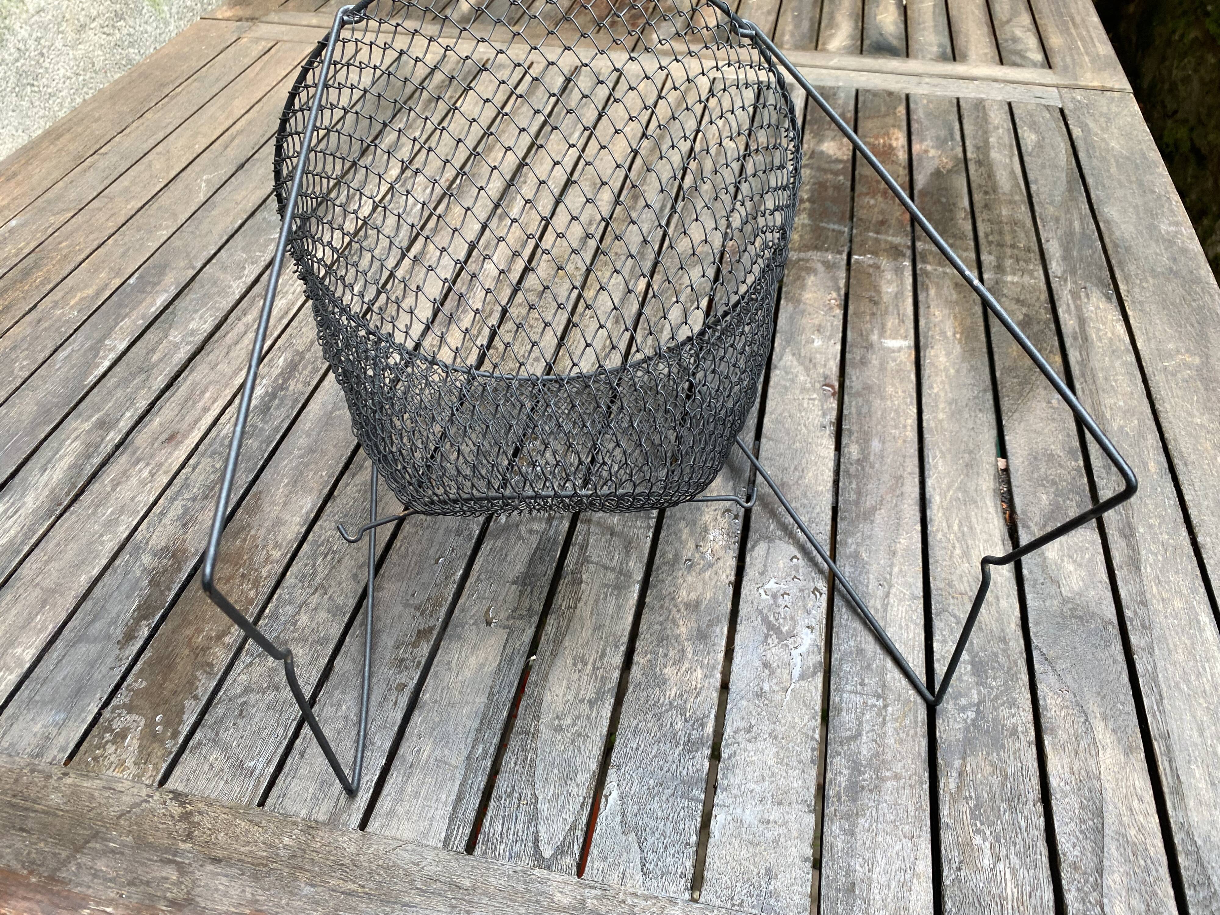 Foldable black woven metal wastepaper basket from around 1950.