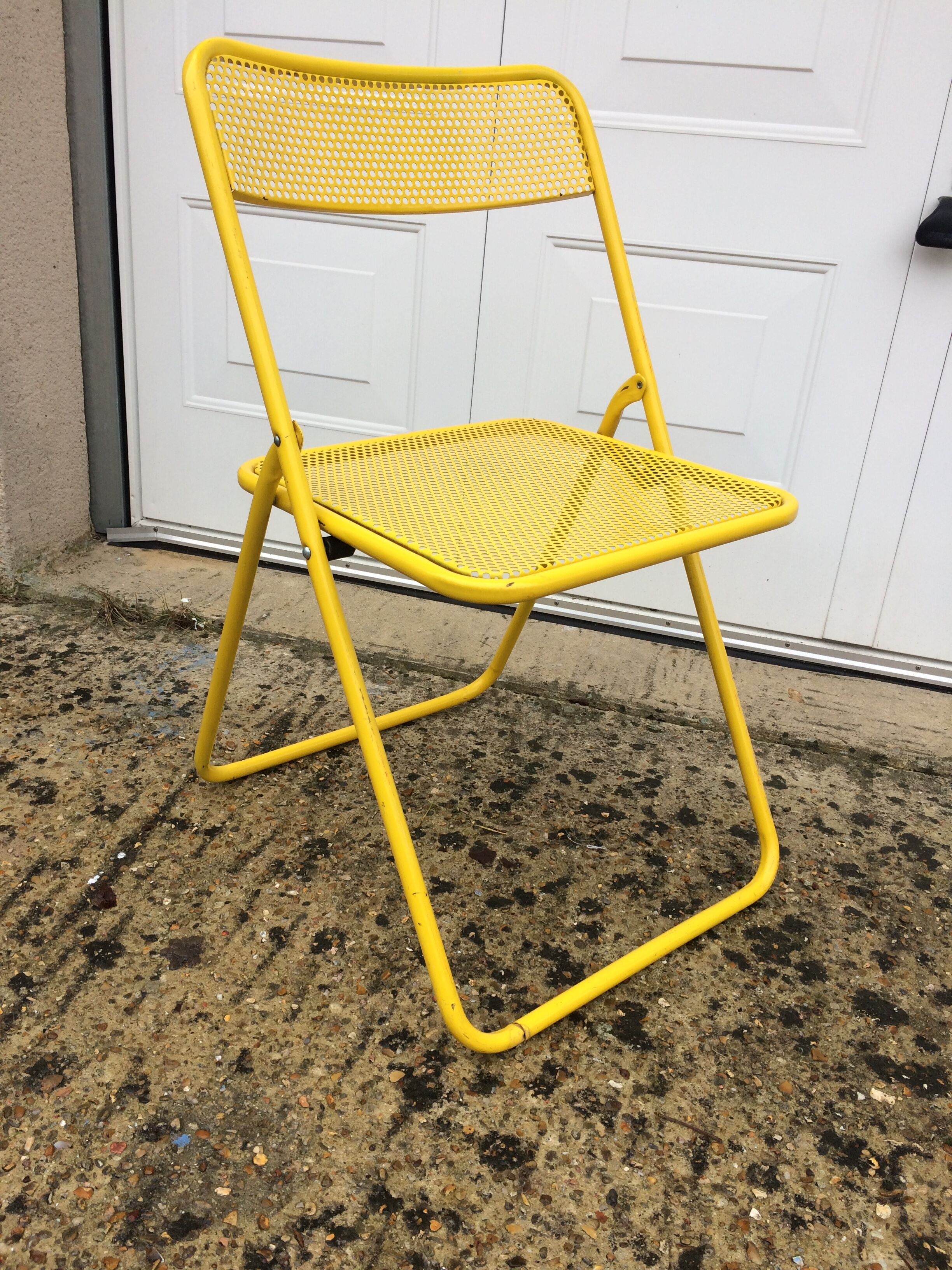Perforated folding metal chair