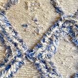 Berber cream carpet with blue patterns