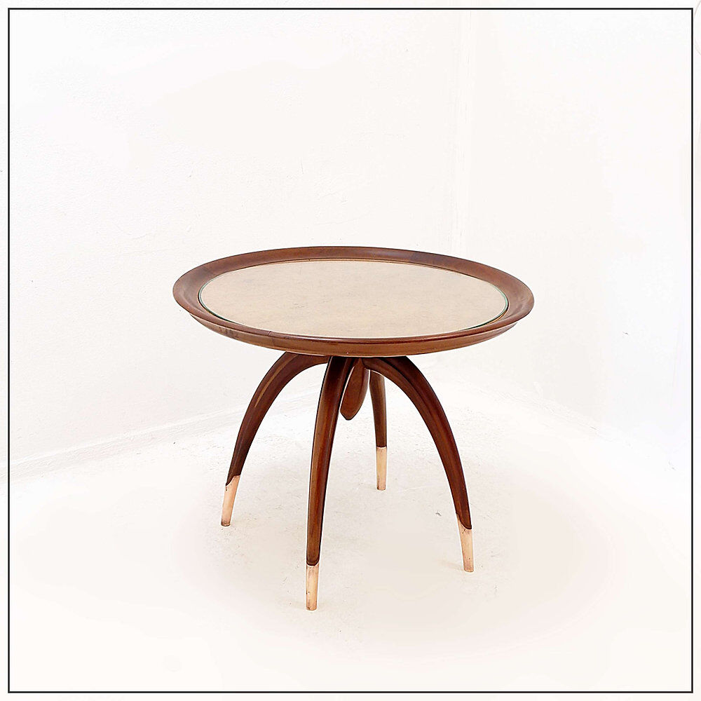 Round Art Deco side table in wood with curved legs and brass feet.