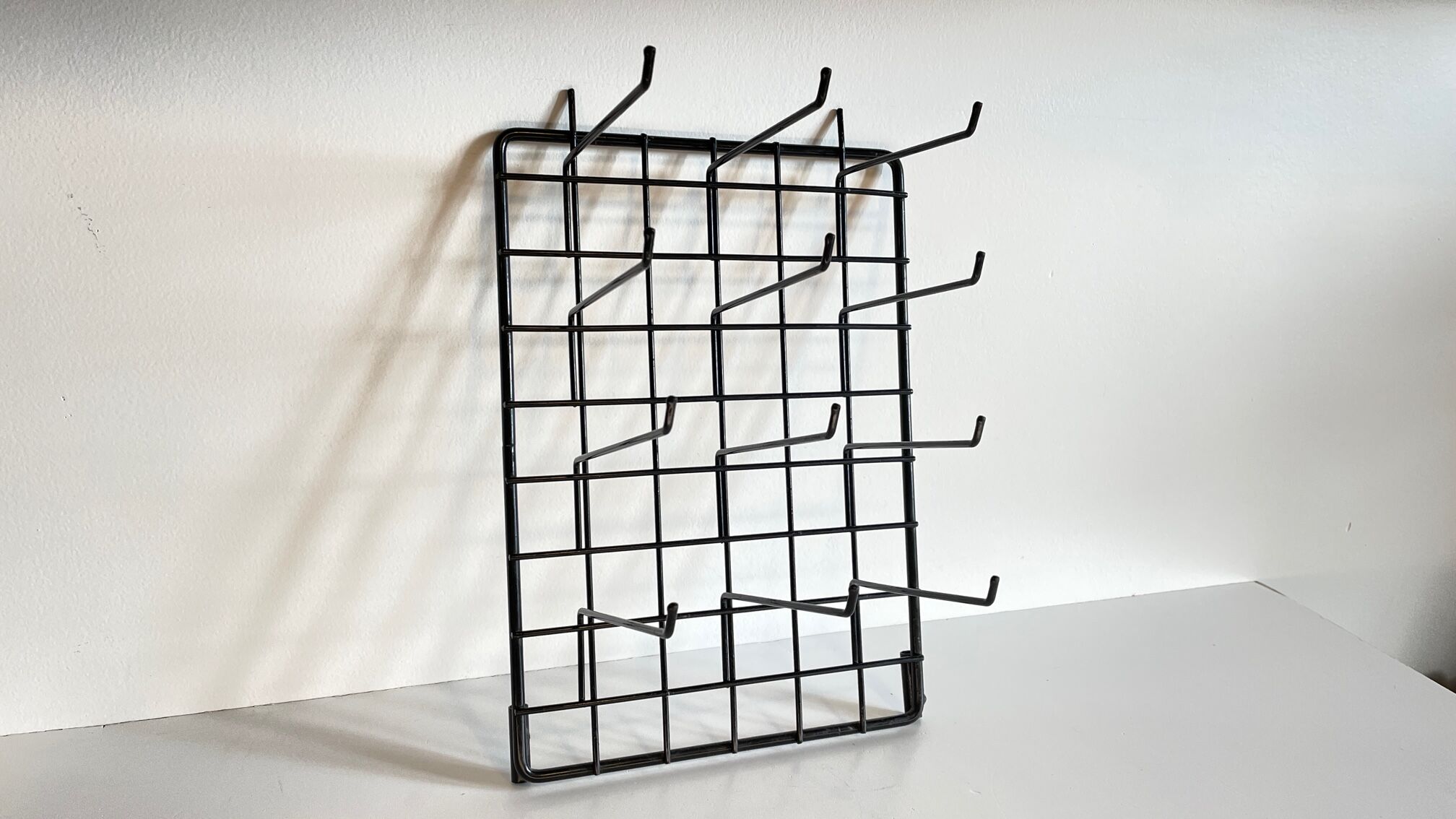 Vintage black metal wall loom display
