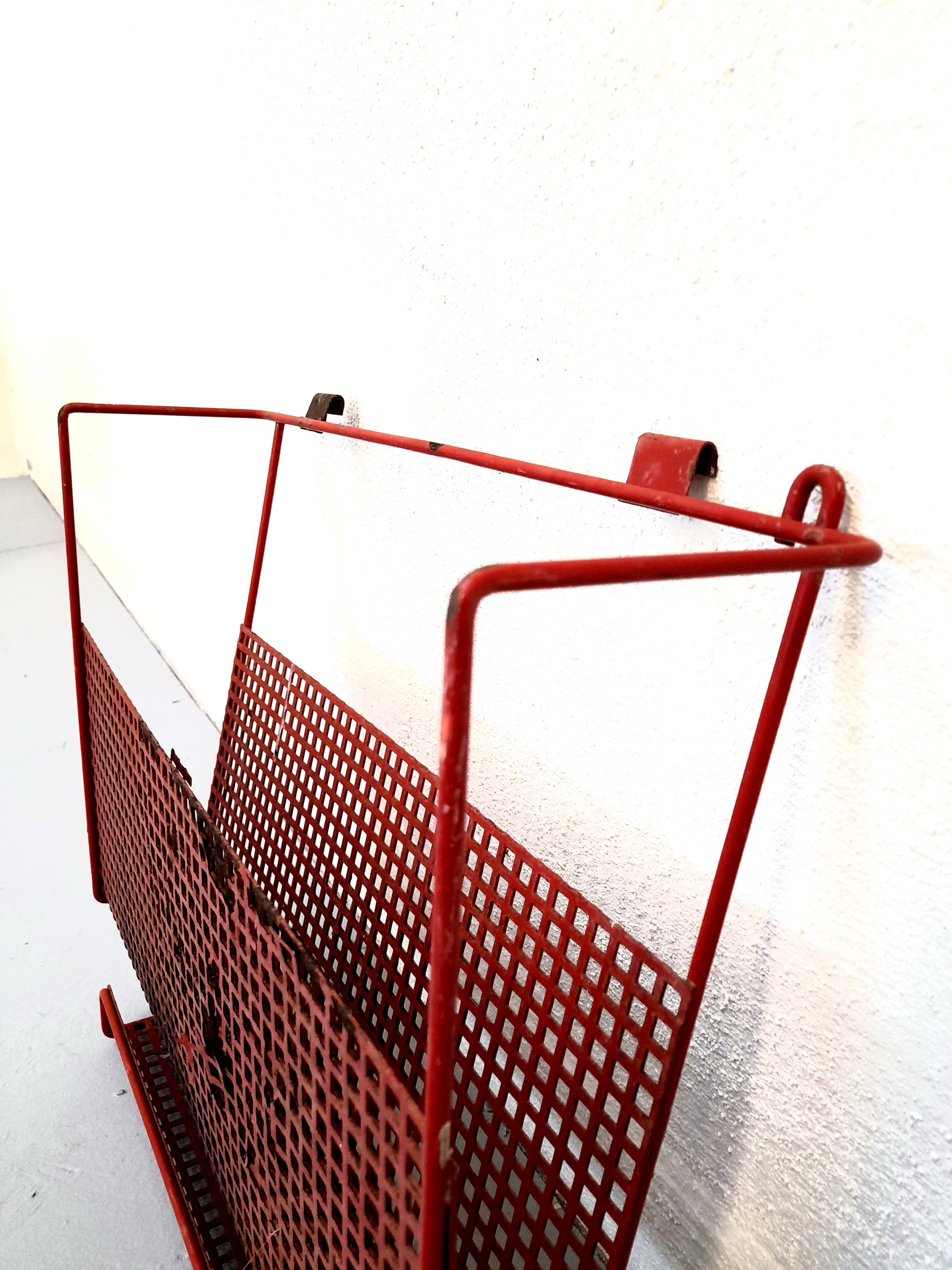 Vintage magazine rack in red lacquered perforated metal from the 70s