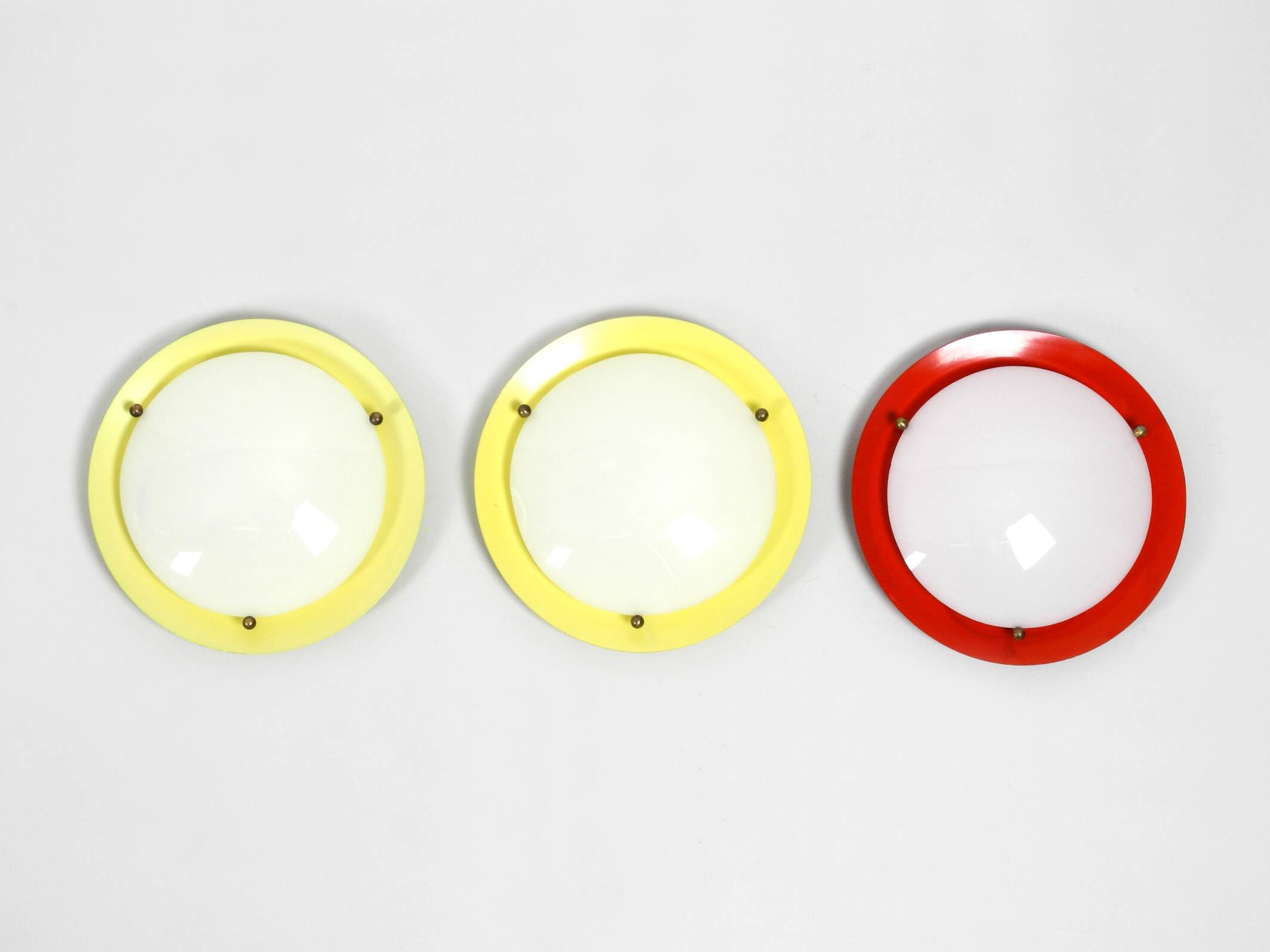 Three round 1950s wall or ceiling lamps made of metal and plexiglass shades