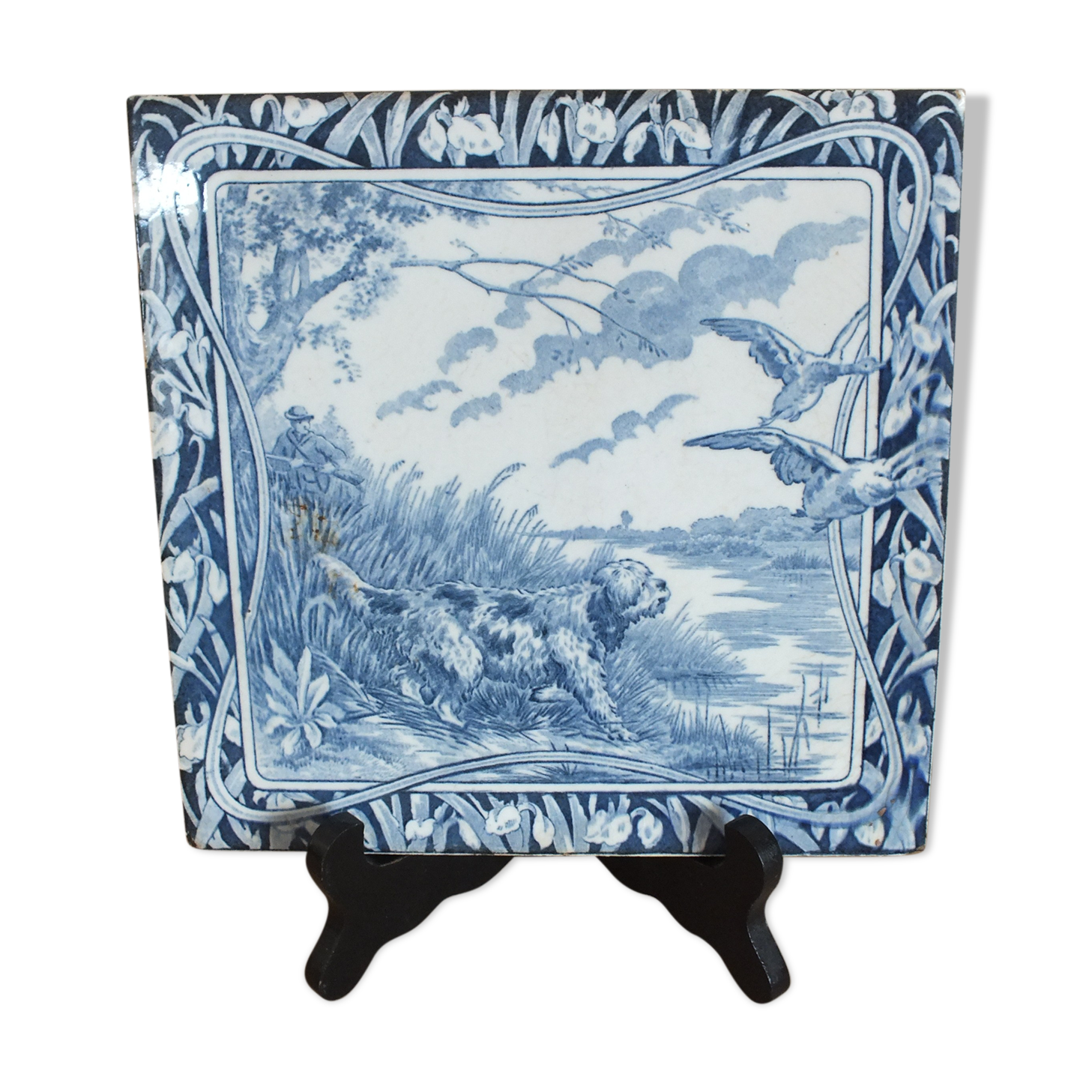 Old tile in Gien earthenware decoration hunting dog