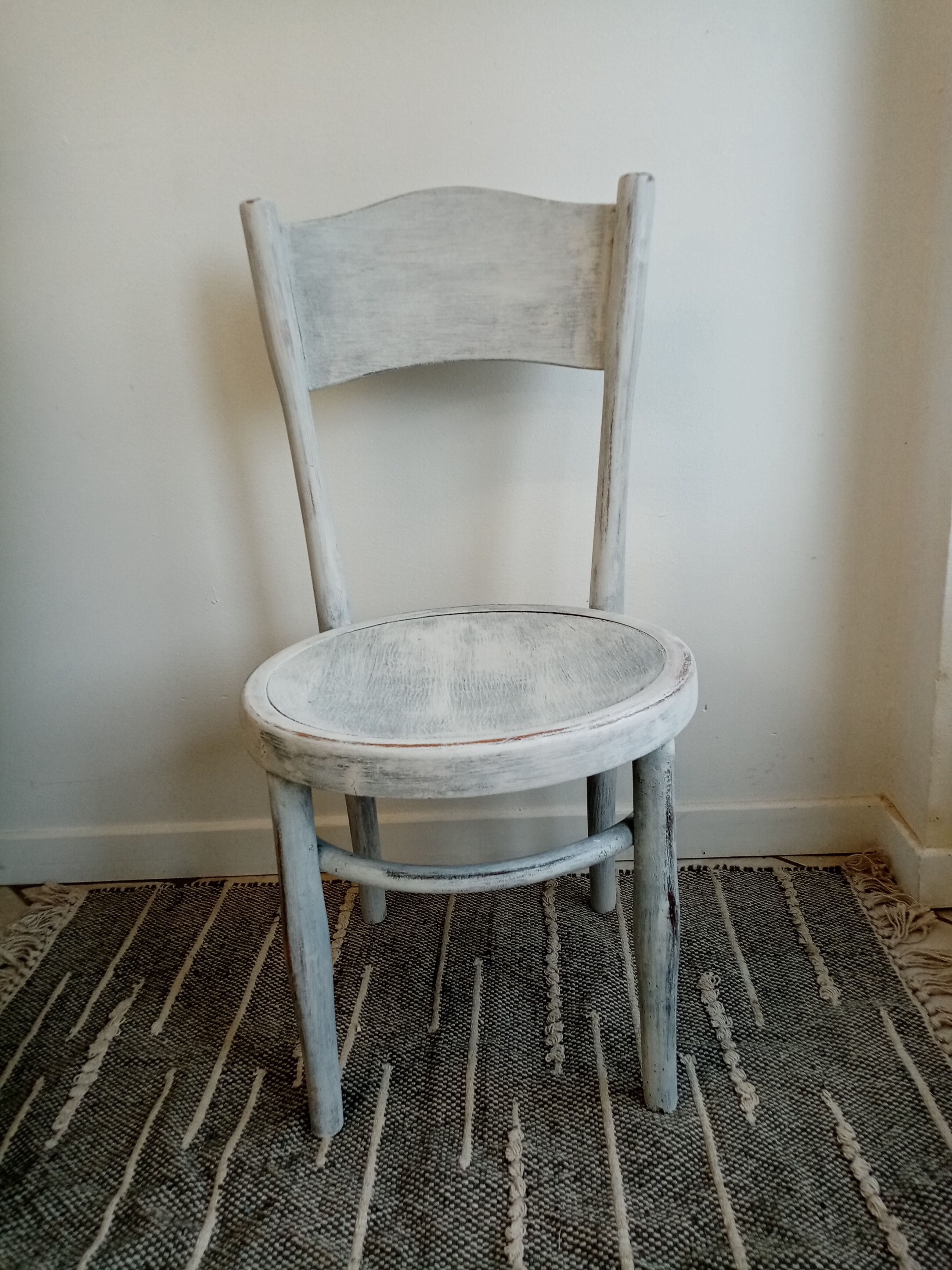 White antique children's chair in patinated wood