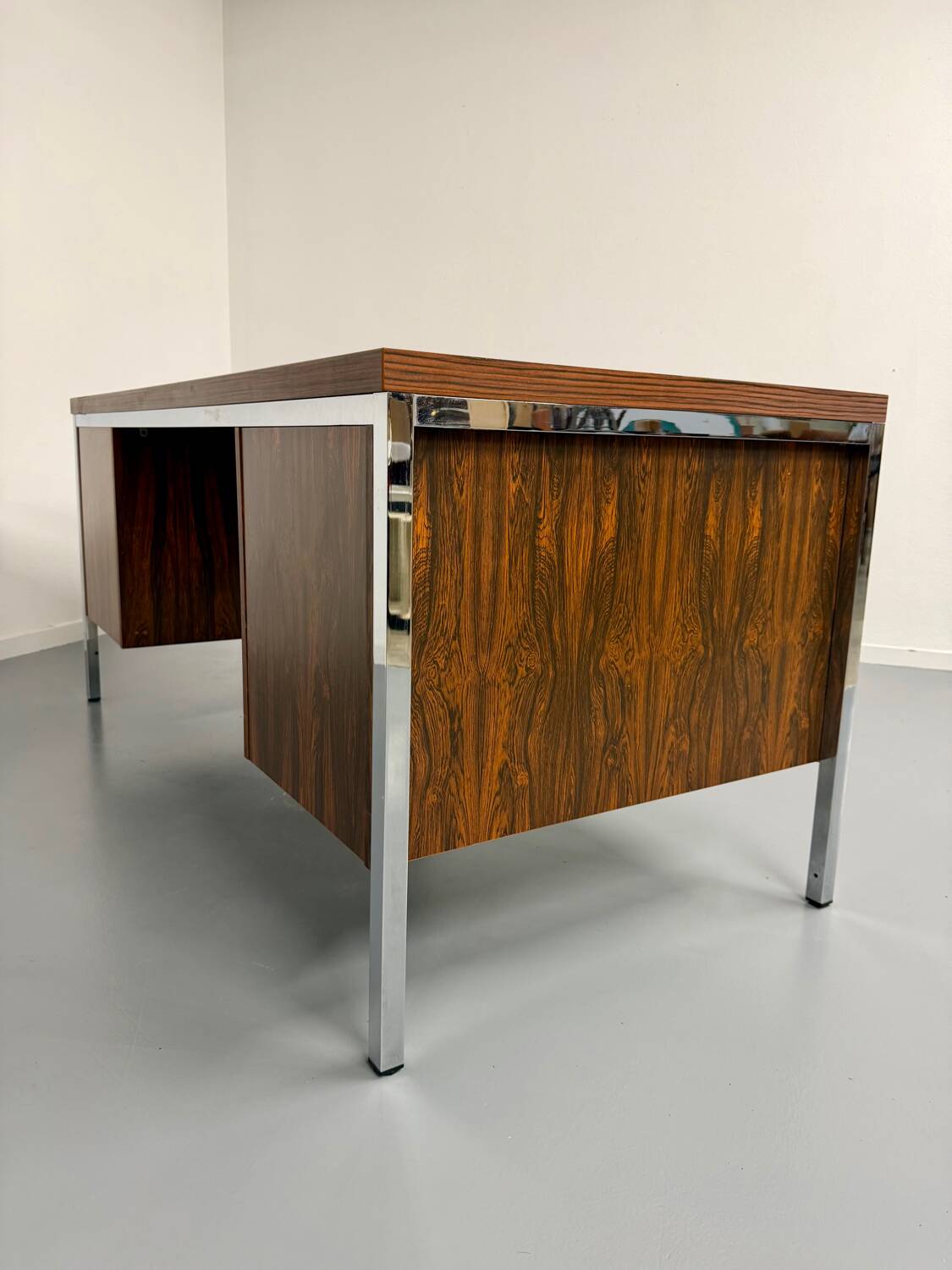 Vintage desk with rosewood veneer and chrome metal design from the 1970s.
