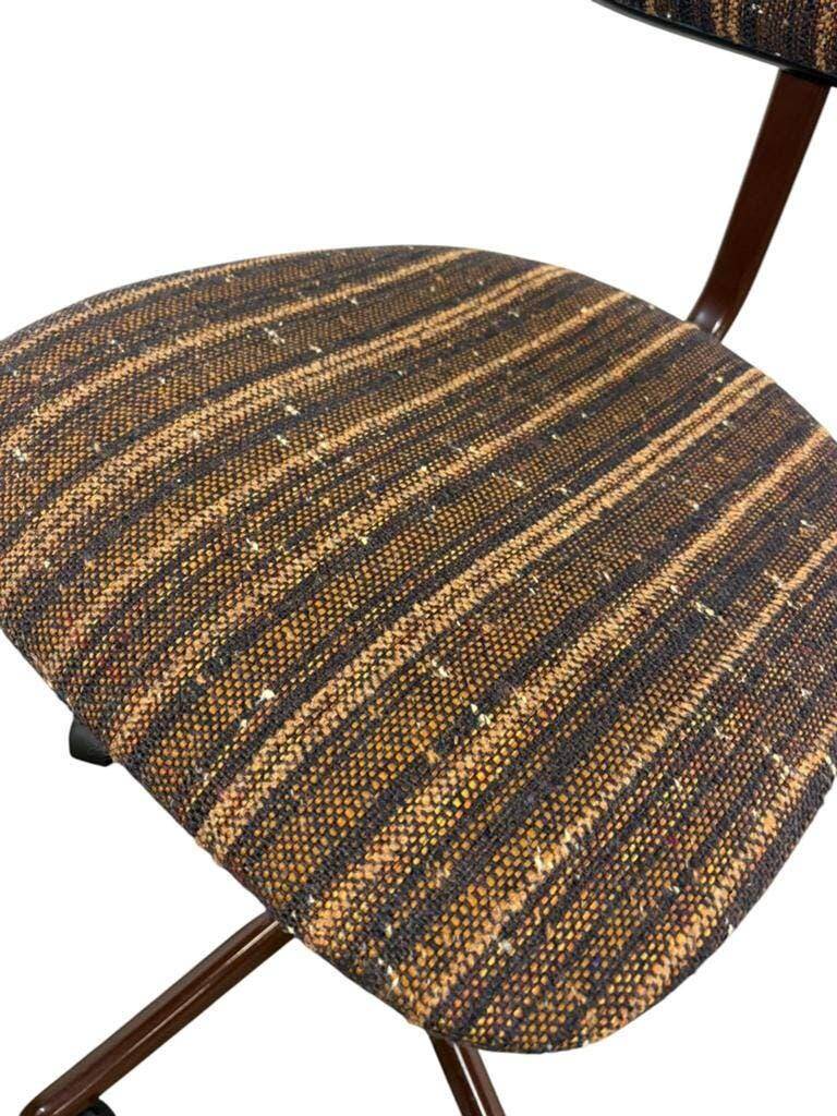 Brown vintage office chair from the 70s on wheels.