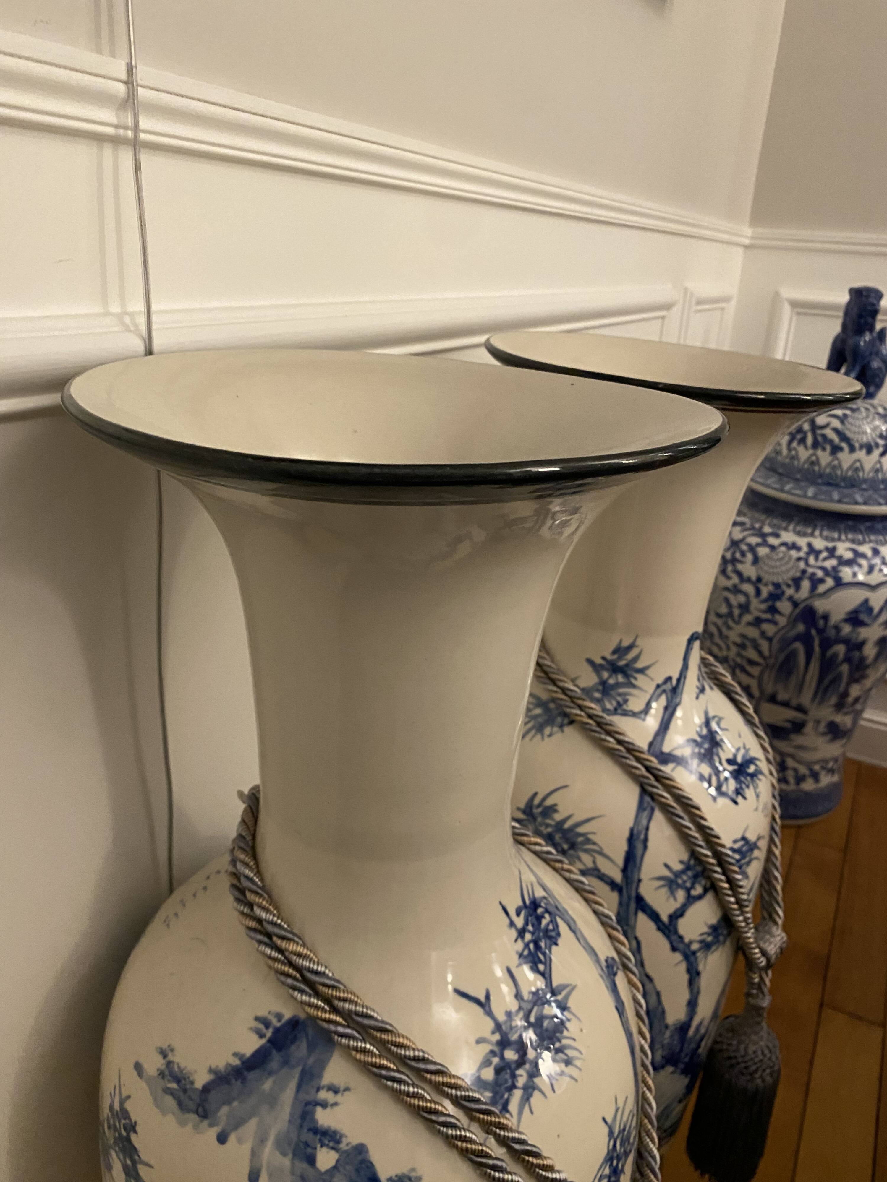 Set of two very large white and blue ceramic vases.