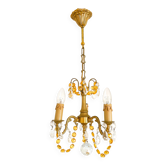 Small vintage chandelier in brass with amber crystal pendants.