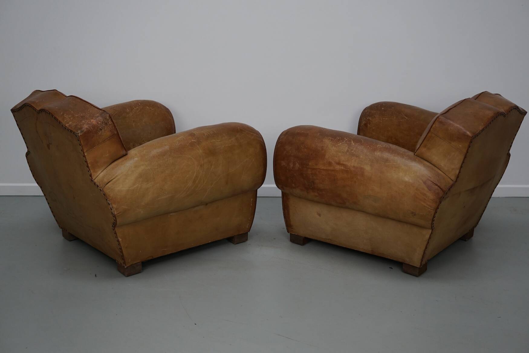 Pair of French club chairs with moustache back in cognac leather, 1940s