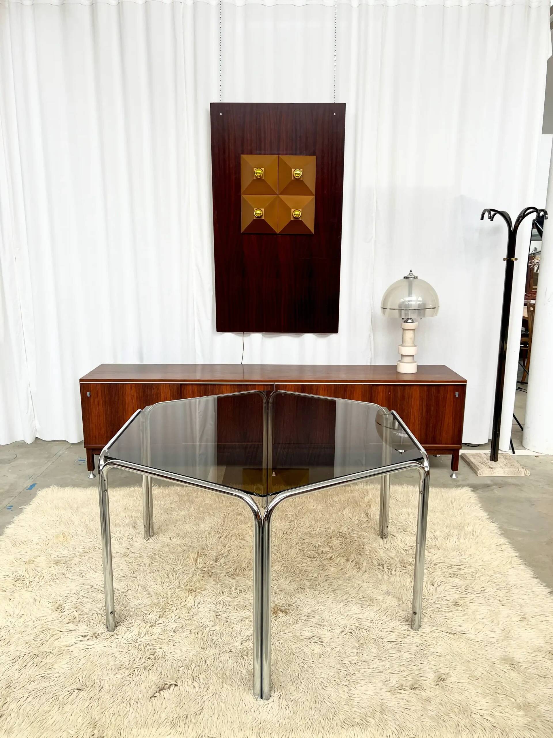 Vintage hexagonal table with smoked glass top and chrome metal structure.