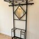 Antique black wrought iron coat rack with mirror.