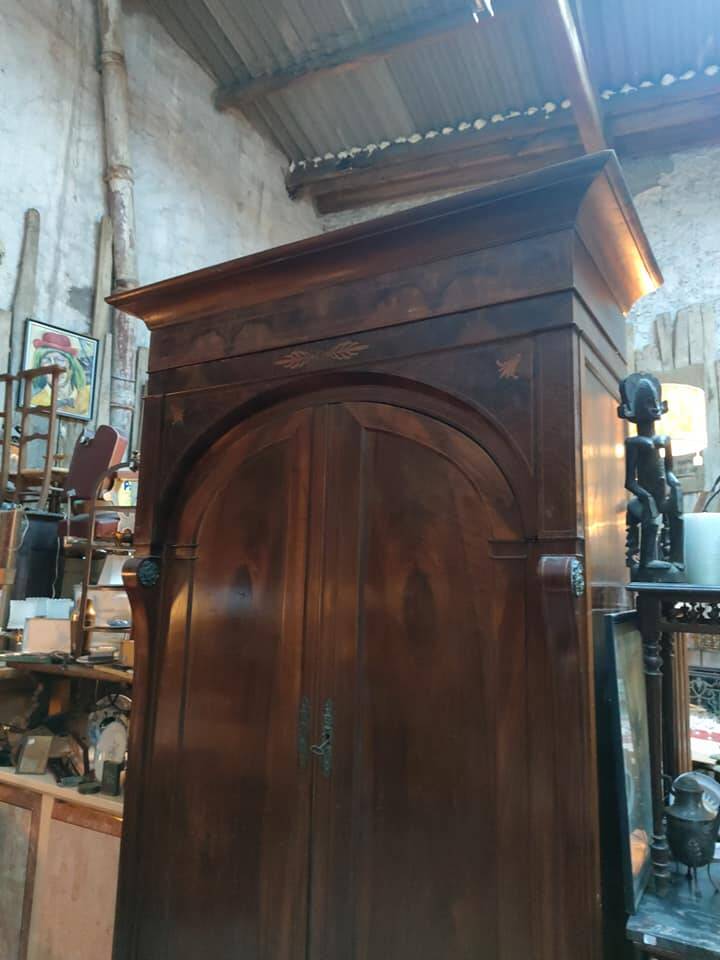 A walnut wardrobe with marquetry and boxwood stringing, dating from the Consulate period, circa 1810.